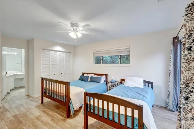 a bedroom with two beds and a chandelier