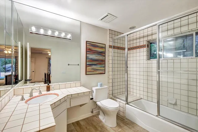 a bedroom with a bed chandelier and a window