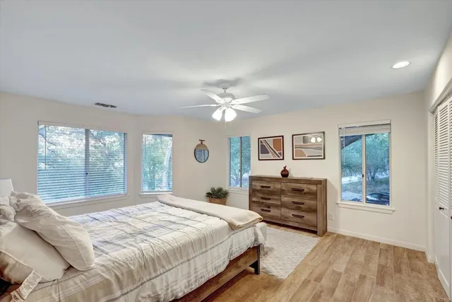 a bedroom with a bed window and a chandelier