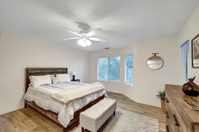 a bathroom with a sink a toilet a mirror and shower