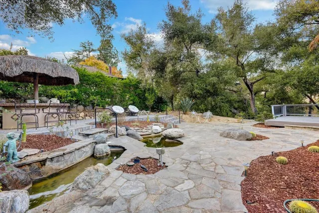 an aerial view of a house with garden space and street view