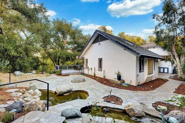 a view of a lush green hillside and houses