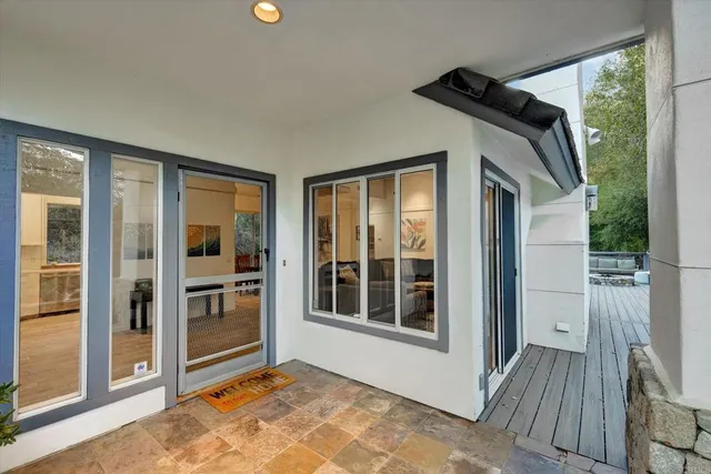 a view of front door and porch with wooden floor