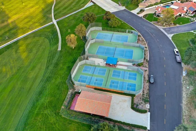 a balcony with wooden floor and outdoor seating