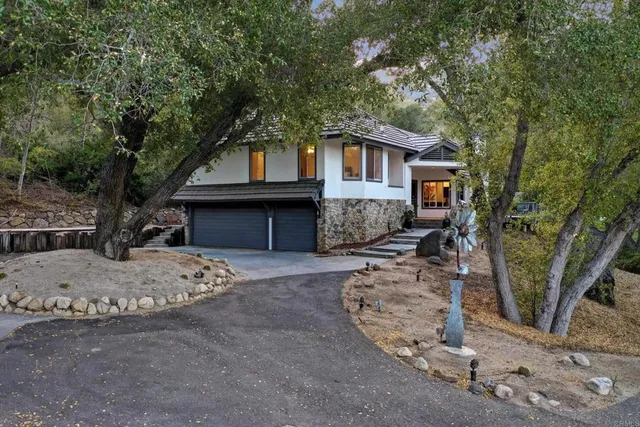 a front view of a house with a garden and deck