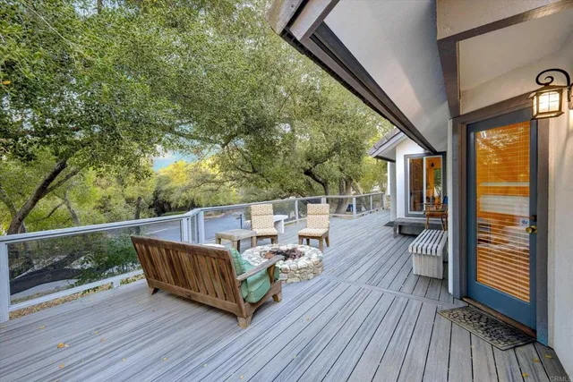 a view of balcony with wooden floor and outdoor seating