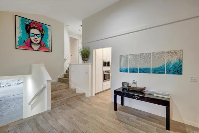 a living room with furniture and a painting on the wall