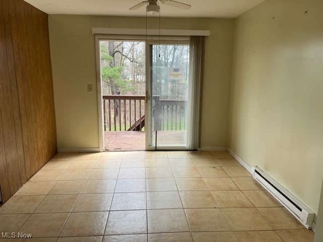 15365 Nash Road Burton, OH 44021 - Photo 7 of 24 Unfurnished dining area with light tile patterned floors, a baseboard radiator, ceiling fan, and baseboards
