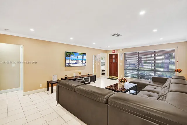 a living room with furniture and a floor to ceiling window