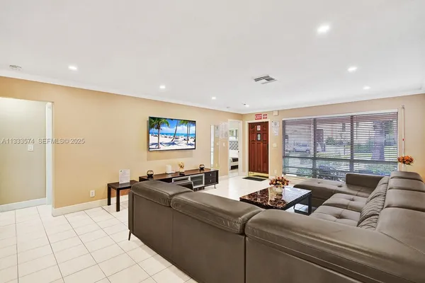 a living room with furniture and a floor to ceiling window