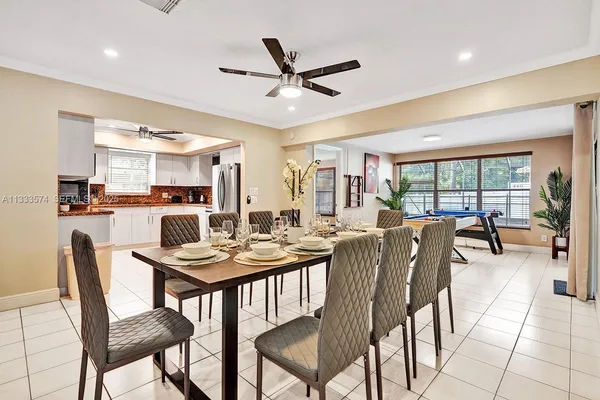 a dining room with furniture and a view of kitchen