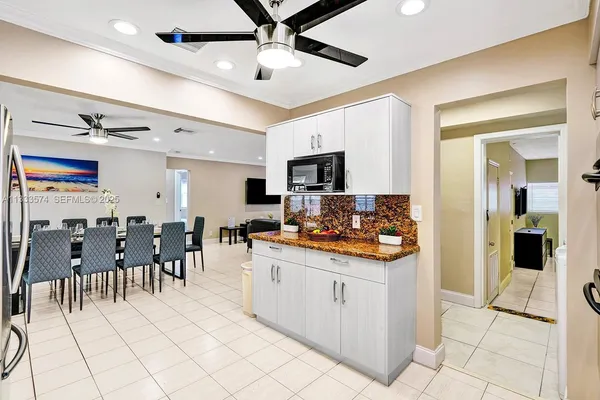 a kitchen with stainless steel appliances kitchen island granite countertop a refrigerator and a stove top oven