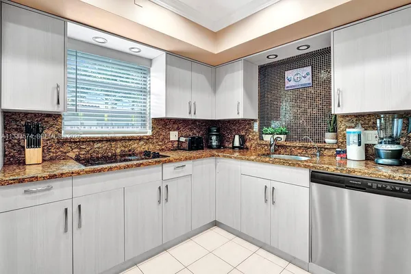 a kitchen with sink cabinets and window