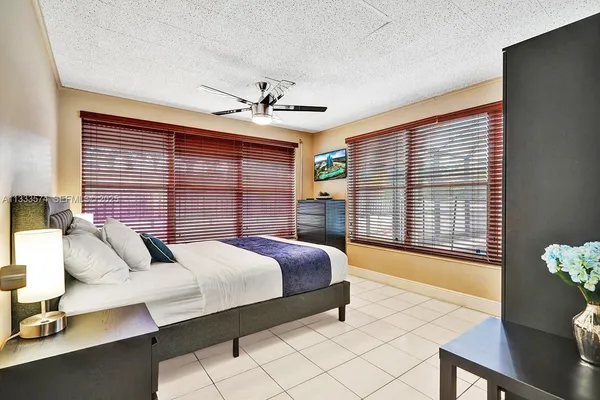 a bedroom with a large bed and a chandelier