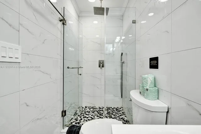 a bathroom with a toilet sink shower and mirror
