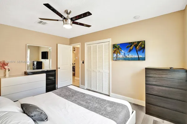 a bedroom with a bed and a cabinet