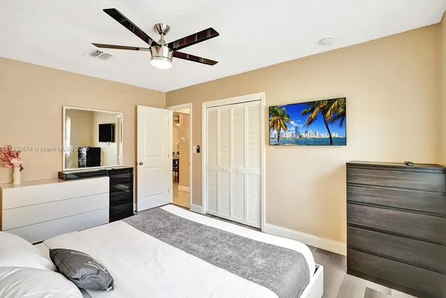 a bedroom with a bed and a cabinet