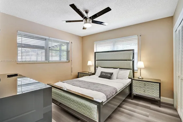 a bedroom with a bed and a ceiling fan