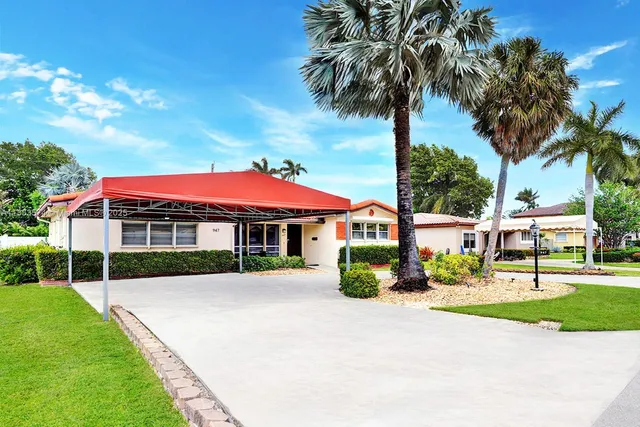 a view of house with outdoor space and tall trees