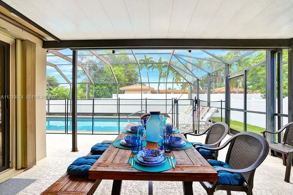 a living room with furniture and floor to ceiling windows