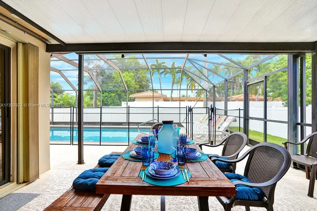 a living room with furniture and floor to ceiling windows