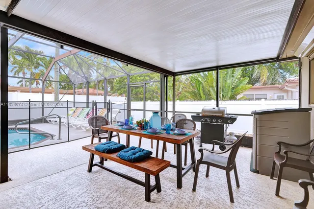 a view of a city from a dining room with large windows and wooden floor