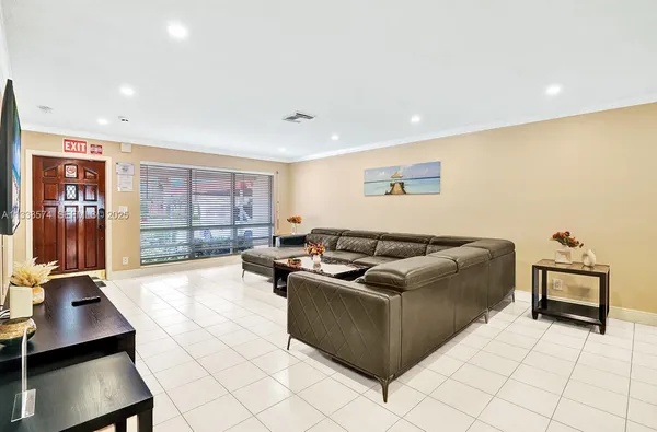 a living room with couches and projector with the screen