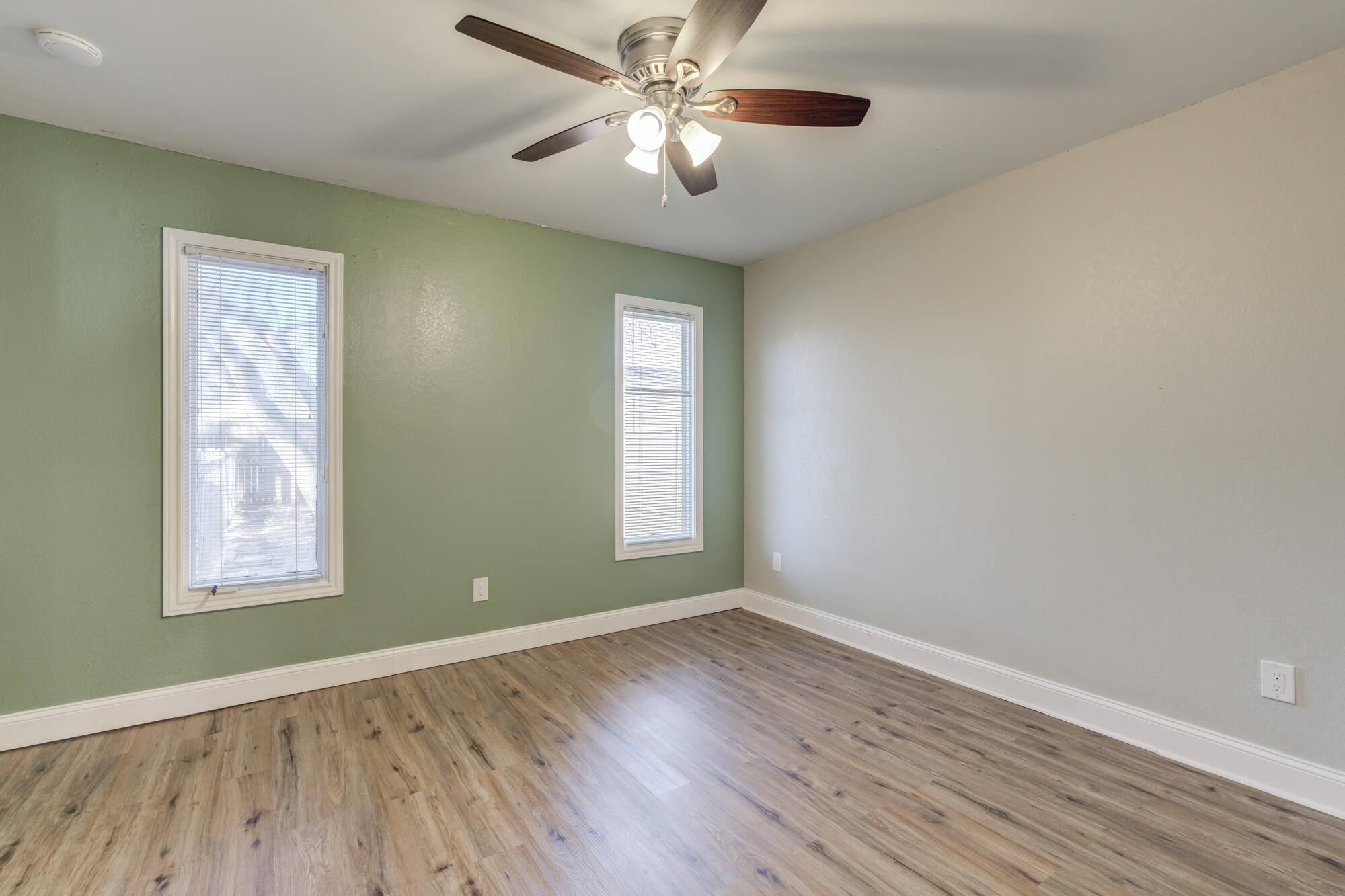 5604 70th Street Lubbock, TX 79424 - Photo 16 of 49 a view of empty room with wooden floor and fan