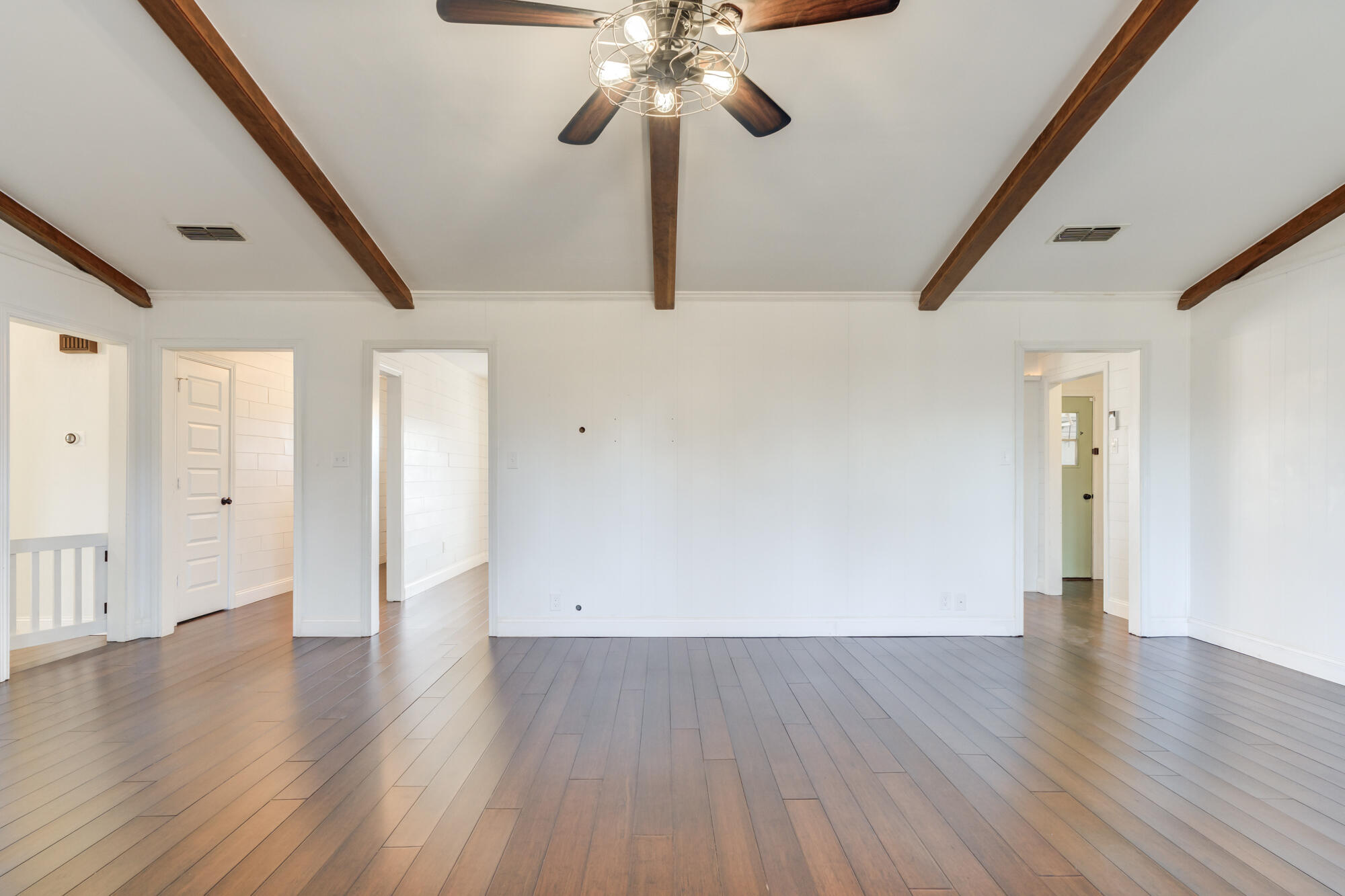 5604 70th Street Lubbock, TX 79424 - Photo 21 of 49 a view of an empty room with wooden floor and a window