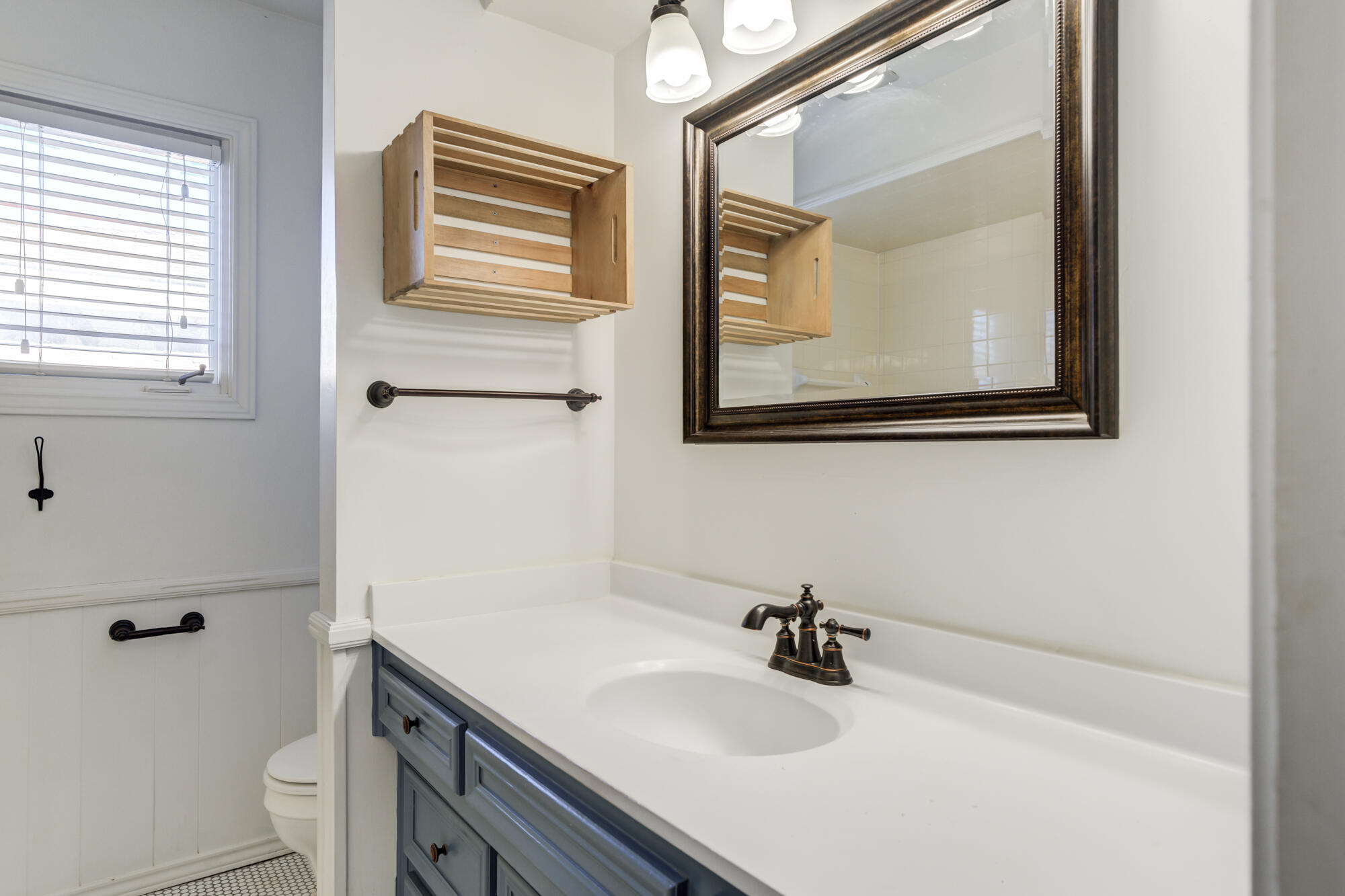 5604 70th Street Lubbock, TX 79424 - Photo 41 of 49 a bathroom with a sink mirror and vanity