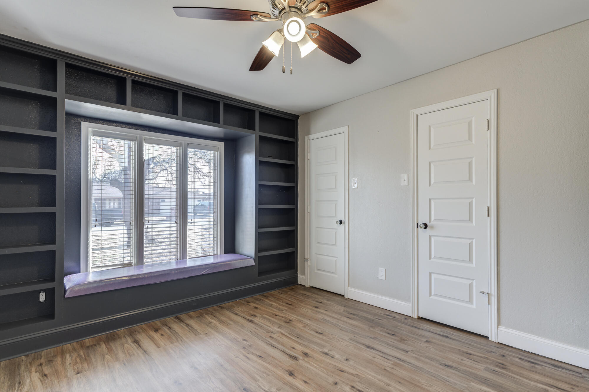5604 70th Street Lubbock, TX 79424 - Photo 43 of 49 a view of empty room with wooden floor and fan