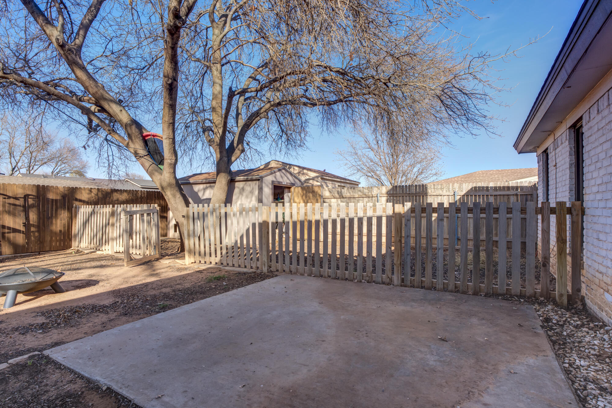 5604 70th Street Lubbock, TX 79424 - Photo 46 of 49 a view of a backyard with wooden fence