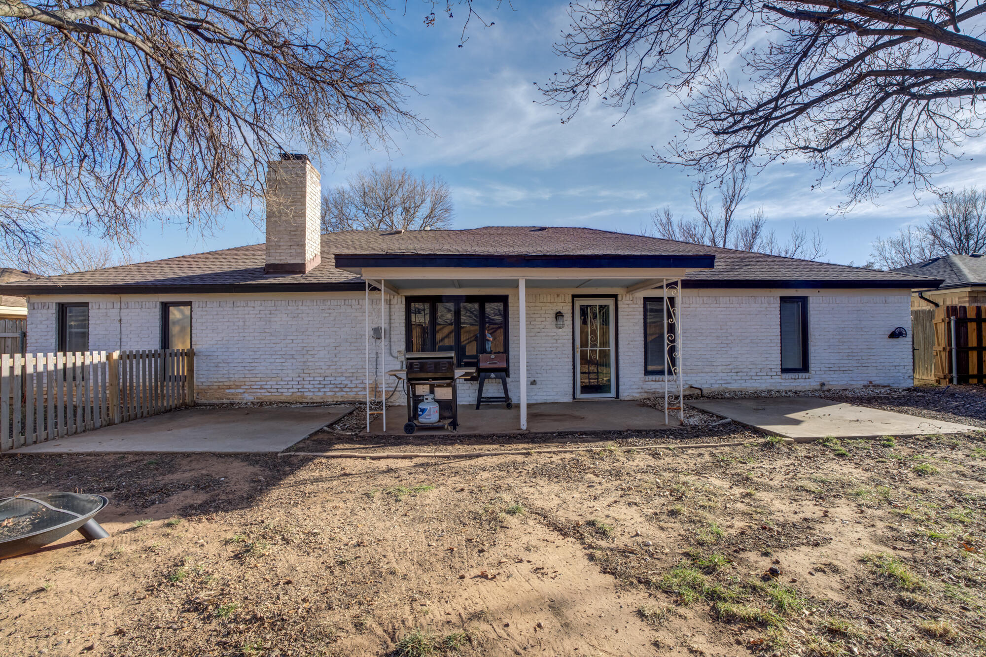 5604 70th Street Lubbock, TX 79424 - Photo 48 of 49 a front view of a house with a yard and wooden fence