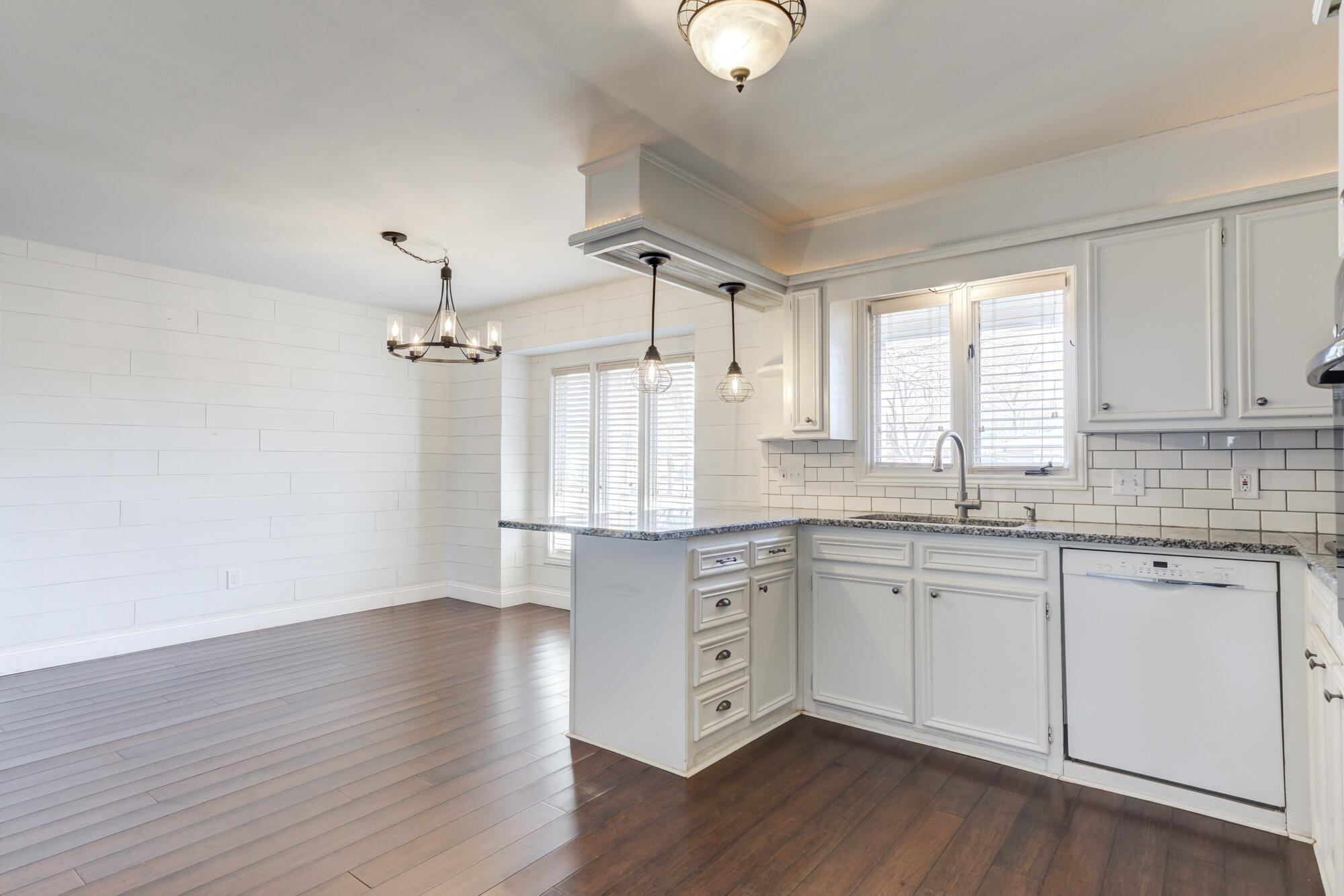 5604 70th Street Lubbock, TX 79424 - Photo 5 of 49 a kitchen with granite countertop white cabinets and white appliances
