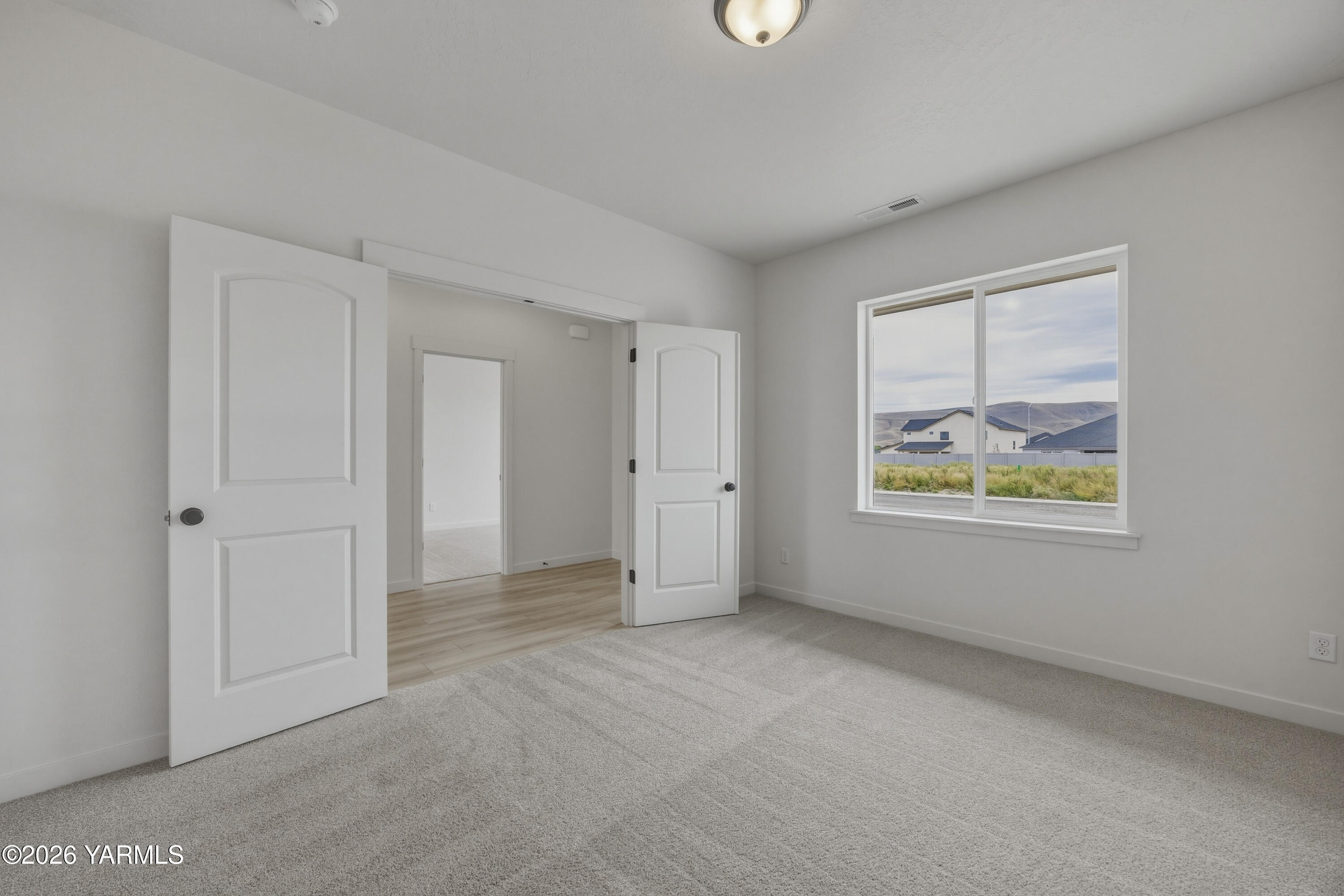 215 Packer Street Prosser, WA 99350 - Photo 31 of 45 a view of an empty room with a window