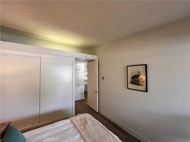 a bedroom with a bed and painting on the wall