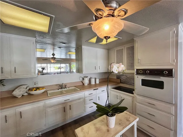 a kitchen with a sink cabinets and window