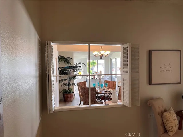 a view of a livingroom with furniture and floor to ceiling window