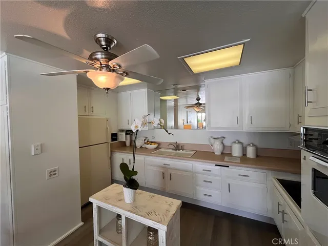 a kitchen with a sink cabinets and appliances