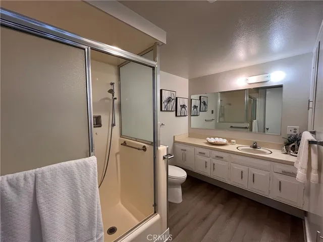 a bathroom with a granite countertop sink mirror bathtub and shower