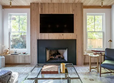 a living room with furniture a window and a fireplace