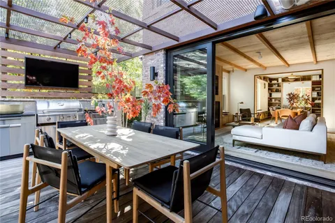 a view of a dining room with furniture wooden floor and flat screen tv