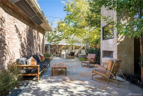 a backyard of a house with barbeque oven table and chairs
