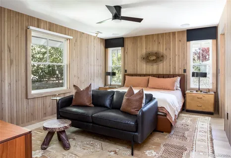 a bedroom with a bed couch and window