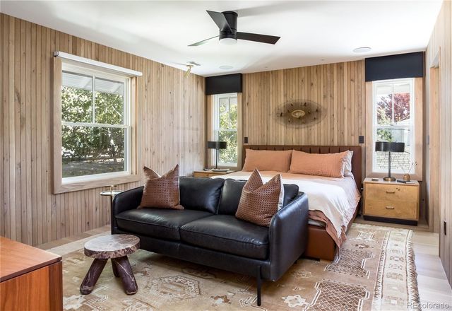 a bedroom with a bed couch and window