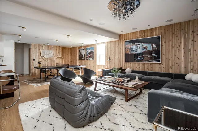 a living room with furniture kitchen view and a window