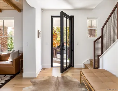 a bedroom with furniture and large window