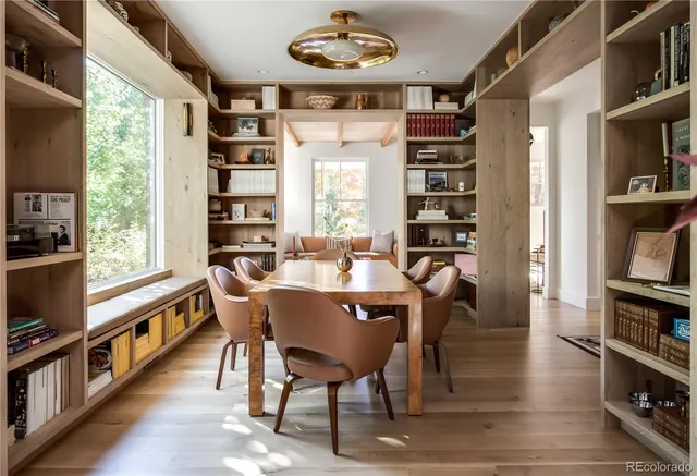 a dining room with furniture and a book shelf