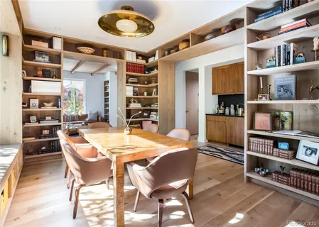 a dining room with furniture and a book shelf