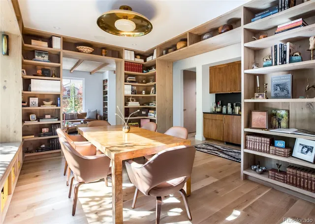 a dining room with furniture and a book shelf
